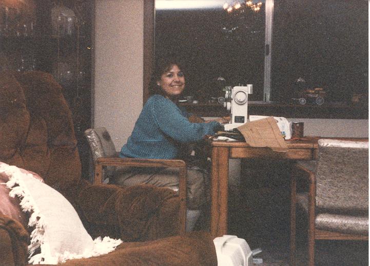 Donna sewing a dress for Kelly and her doll at Mom's 1986